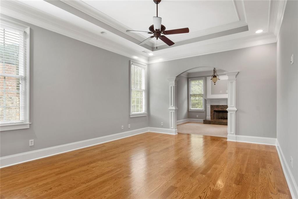 4387 Old Fairburn Road Atlanta, GA 30349 - Photo 16 of 21 a view of a livingroom with wooden floor and a ceiling fan