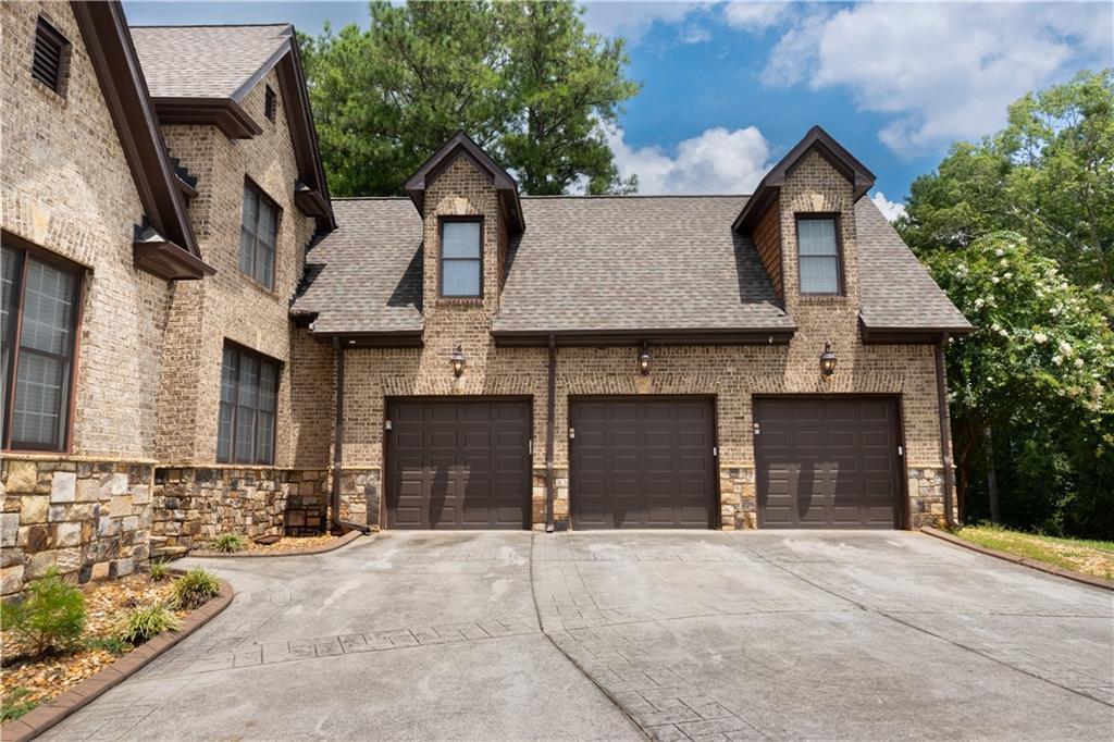 4387 Old Fairburn Road Atlanta, GA 30349 - Photo 3 of 21 a front view of a house with a yard and garage