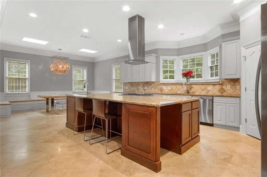 4387 Old Fairburn Road Atlanta, GA 30349 - Photo 6 of 21 a kitchen with stainless steel appliances granite countertop a sink and a stove