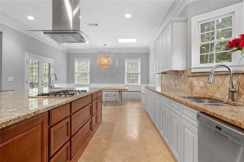 4387 Old Fairburn Road Atlanta, GA 30349 - Photo 8 of 21 a large kitchen with stainless steel appliances granite countertop a lot of counter space and a sink