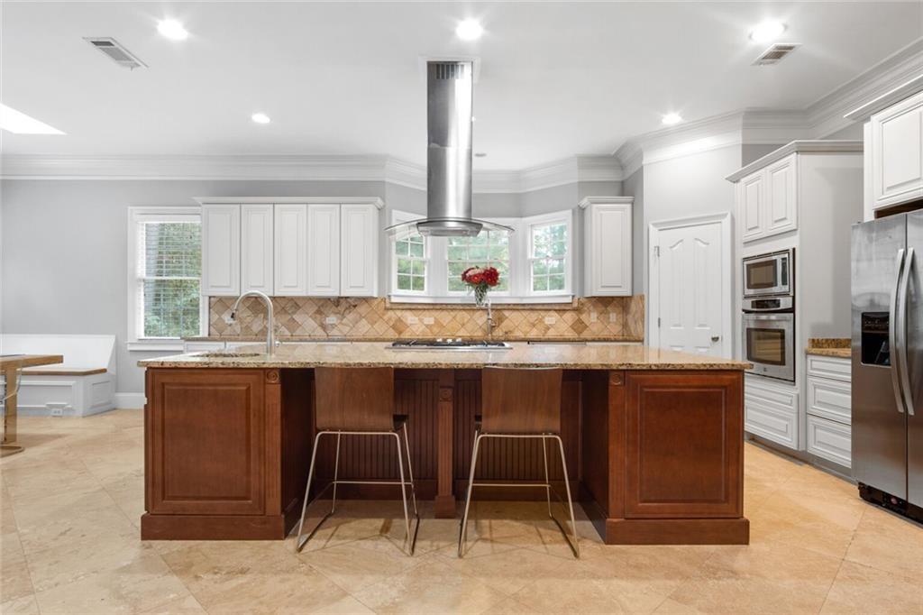 4387 Old Fairburn Road Atlanta, GA 30349 - Photo 9 of 21 a kitchen with stainless steel appliances granite countertop wooden cabinets and a granite counter tops