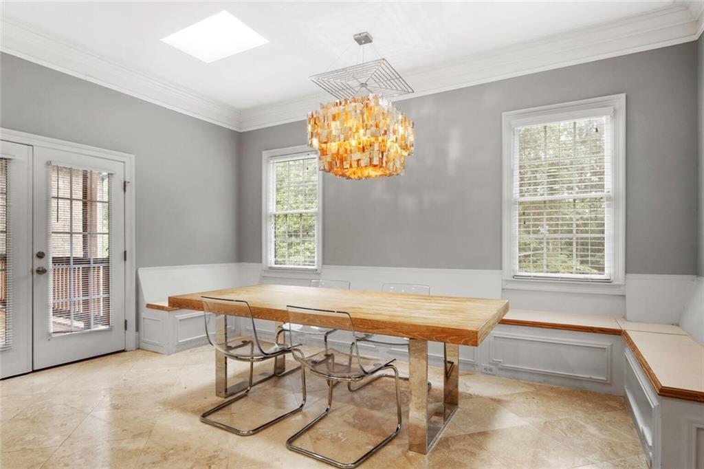4387 Old Fairburn Road Atlanta, GA 30349 - Photo 10 of 21 a view of a dining room with furniture and chandelier