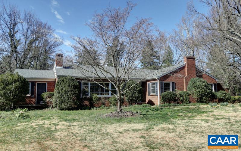1215 Rugby Road Charlottesville, VA 22903 - Photo 1 of 20 a brick house with trees in front of it