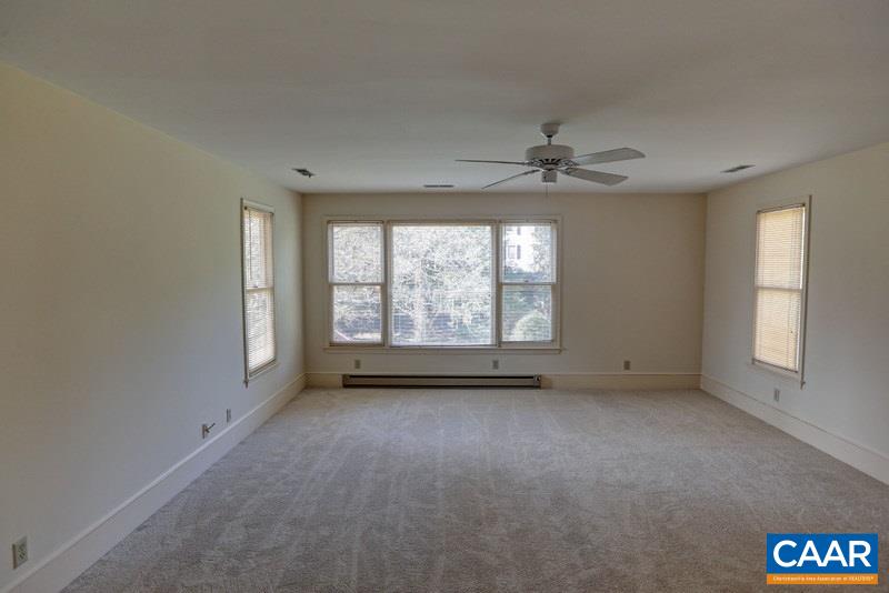 1215 Rugby Road Charlottesville, VA 22903 - Photo 11 of 20 an empty room with windows and chandelier fan