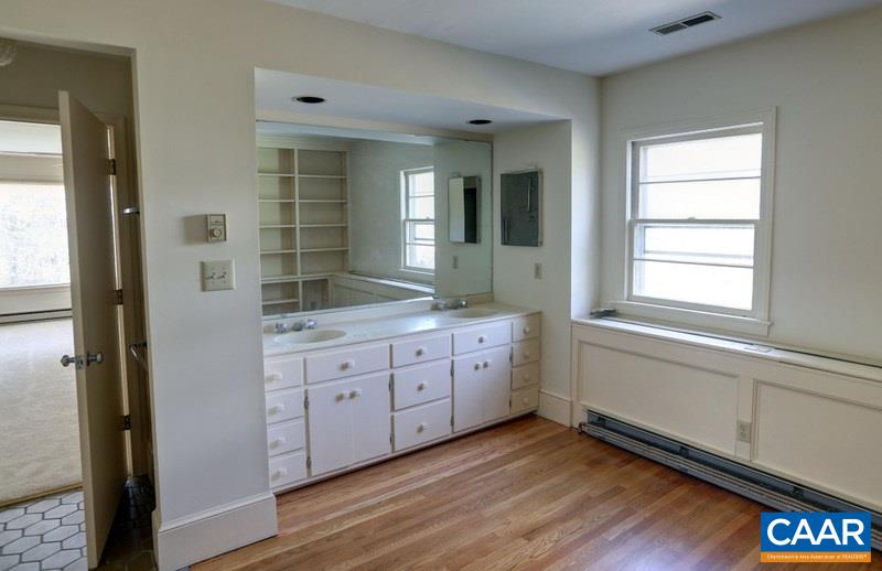 1215 Rugby Road Charlottesville, VA 22903 - Photo 12 of 20 a bathroom with a granite countertop sink and a large mirror