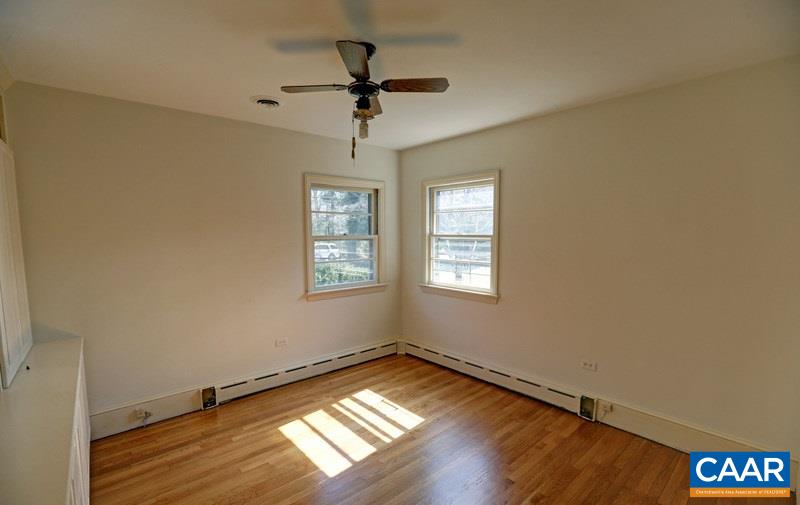 1215 Rugby Road Charlottesville, VA 22903 - Photo 14 of 20 a view of empty room with wooden floor and fan