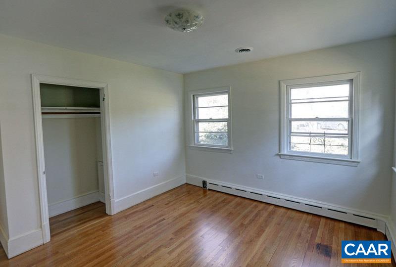 1215 Rugby Road Charlottesville, VA 22903 - Photo 15 of 20 an empty room with wooden floor closet and windows
