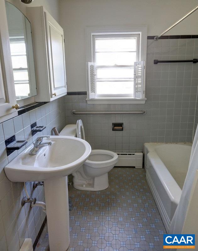 1215 Rugby Road Charlottesville, VA 22903 - Photo 16 of 20 a bathroom with a sink a toilet and a bathtub