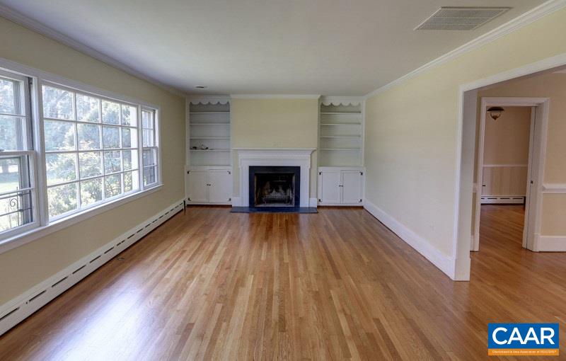 1215 Rugby Road Charlottesville, VA 22903 - Photo 4 of 20 wooden floor fireplace and windows in an empty room