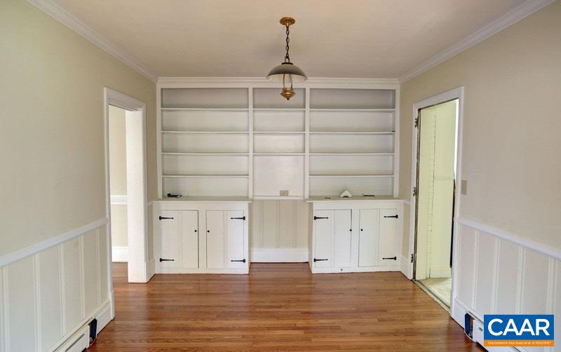 1215 Rugby Road Charlottesville, VA 22903 - Photo 6 of 20 an empty room with cabinet and wooden floor