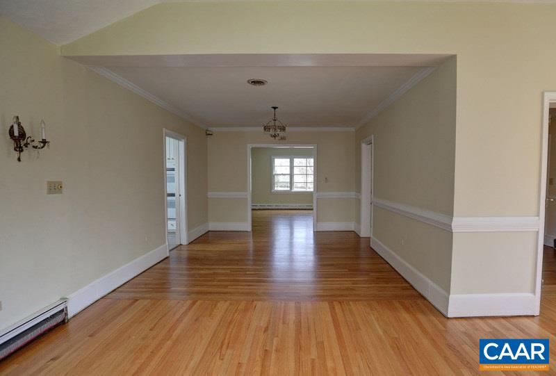 1215 Rugby Road Charlottesville, VA 22903 - Photo 7 of 20 a view of an empty room with wooden floor and a window