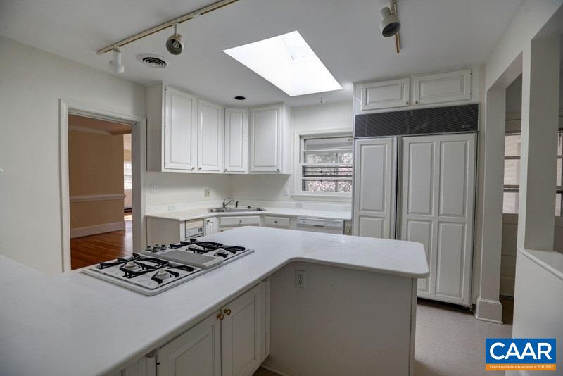 1215 Rugby Road Charlottesville, VA 22903 - Photo 9 of 20 a kitchen with a stove a sink and a refrigerator