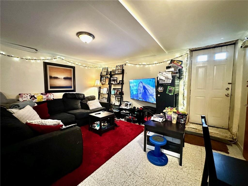 1453 85th Street Brooklyn, NY 11228 - Photo 3 of 18 a living room with furniture potted plant and a window