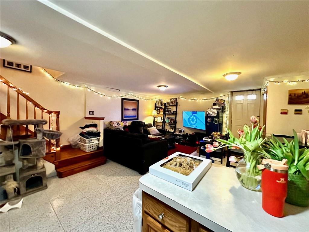 1453 85th Street Brooklyn, NY 11228 - Photo 7 of 18 a living room with furniture and a flat screen tv