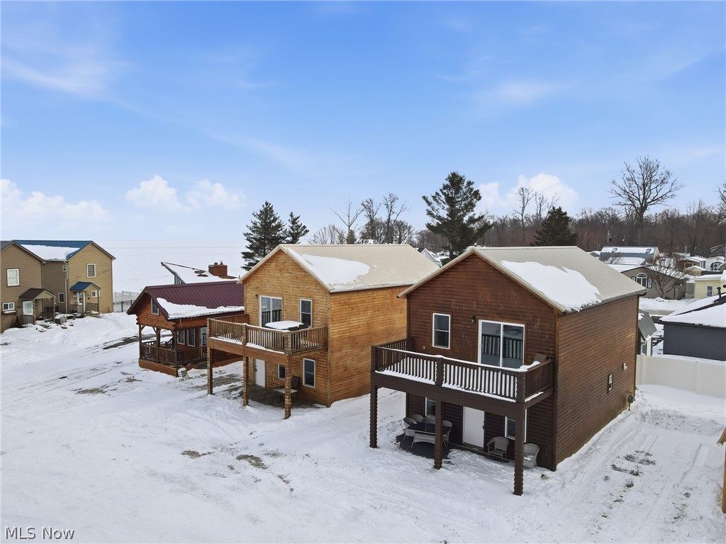 Back of house featuring a deck and a residential view