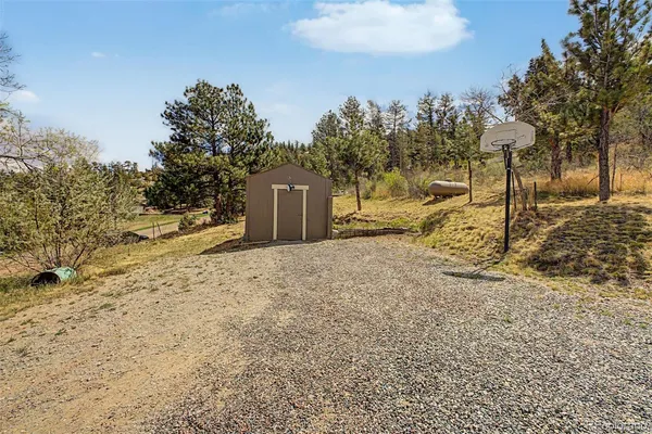 a view of a yard with wooden fence