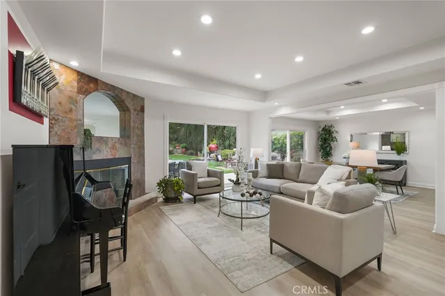 a dining room with furniture potted plants and wooden floor