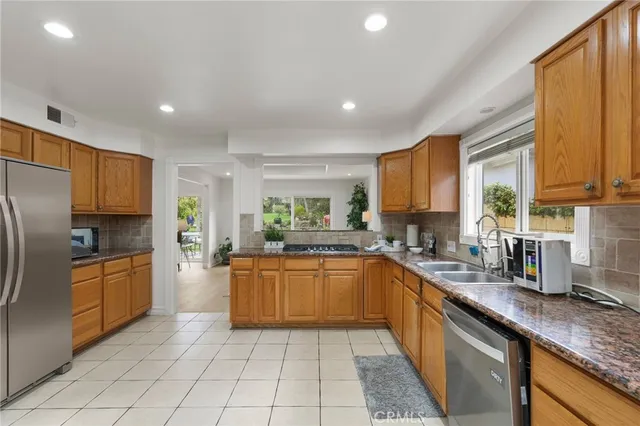 a bathroom with a granite countertop sink mirror vanity and toilet