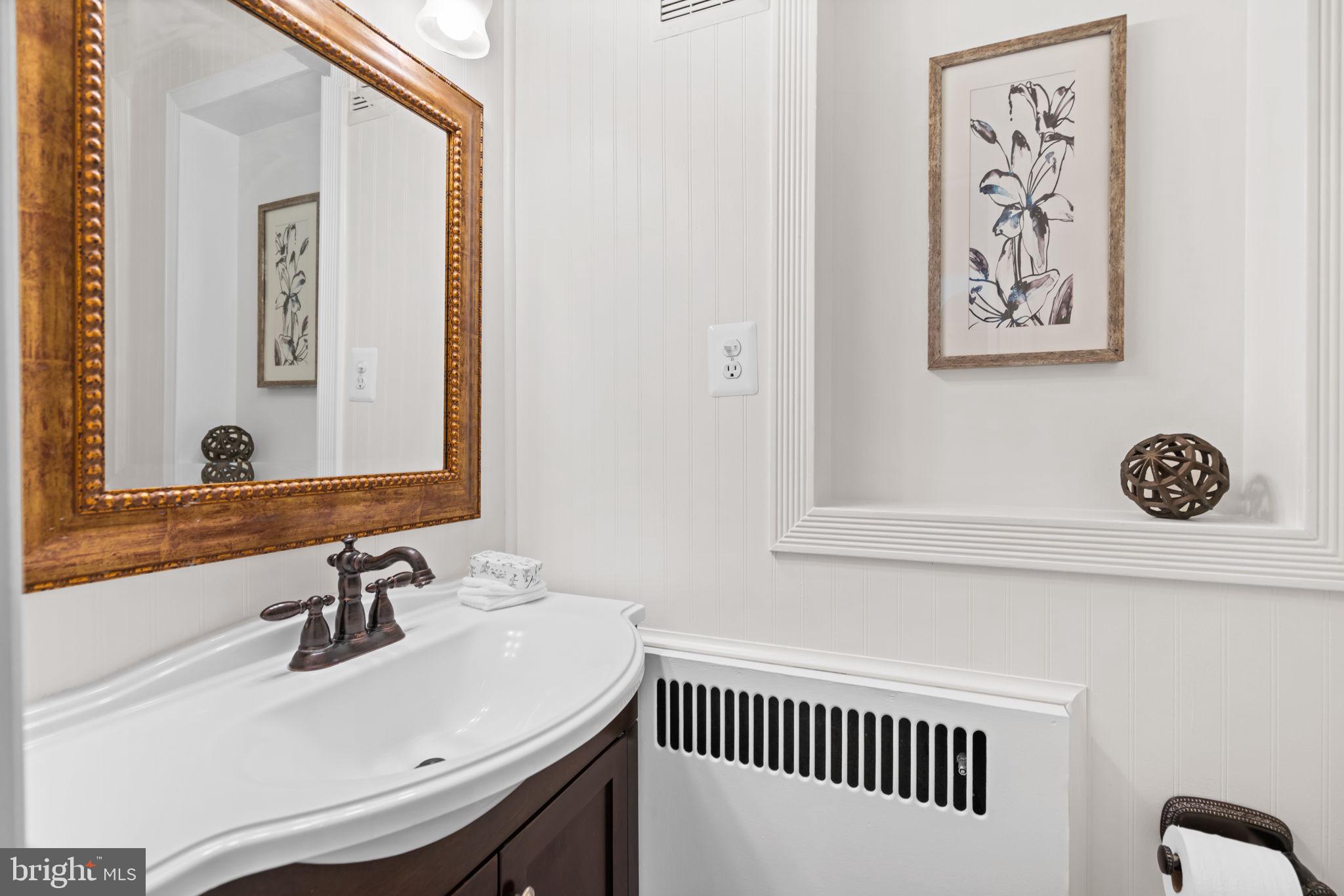 4900 Montgomery Avenue Bethesda, MD 20816 - Photo 14 of 57 a bathroom with a sink and a mirror
