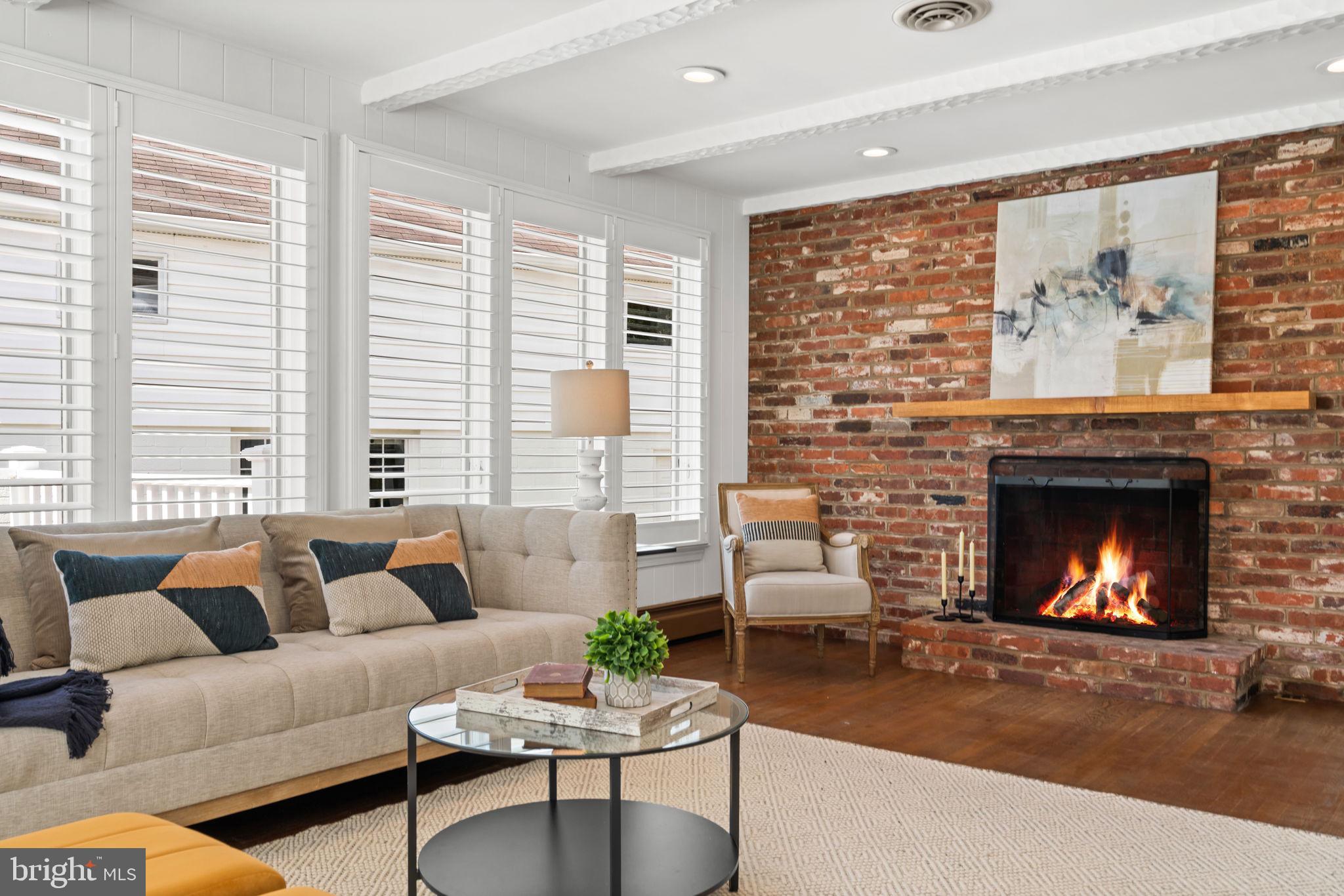 4900 Montgomery Avenue Bethesda, MD 20816 - Photo 18 of 57 a living room with furniture a large window and a fireplace