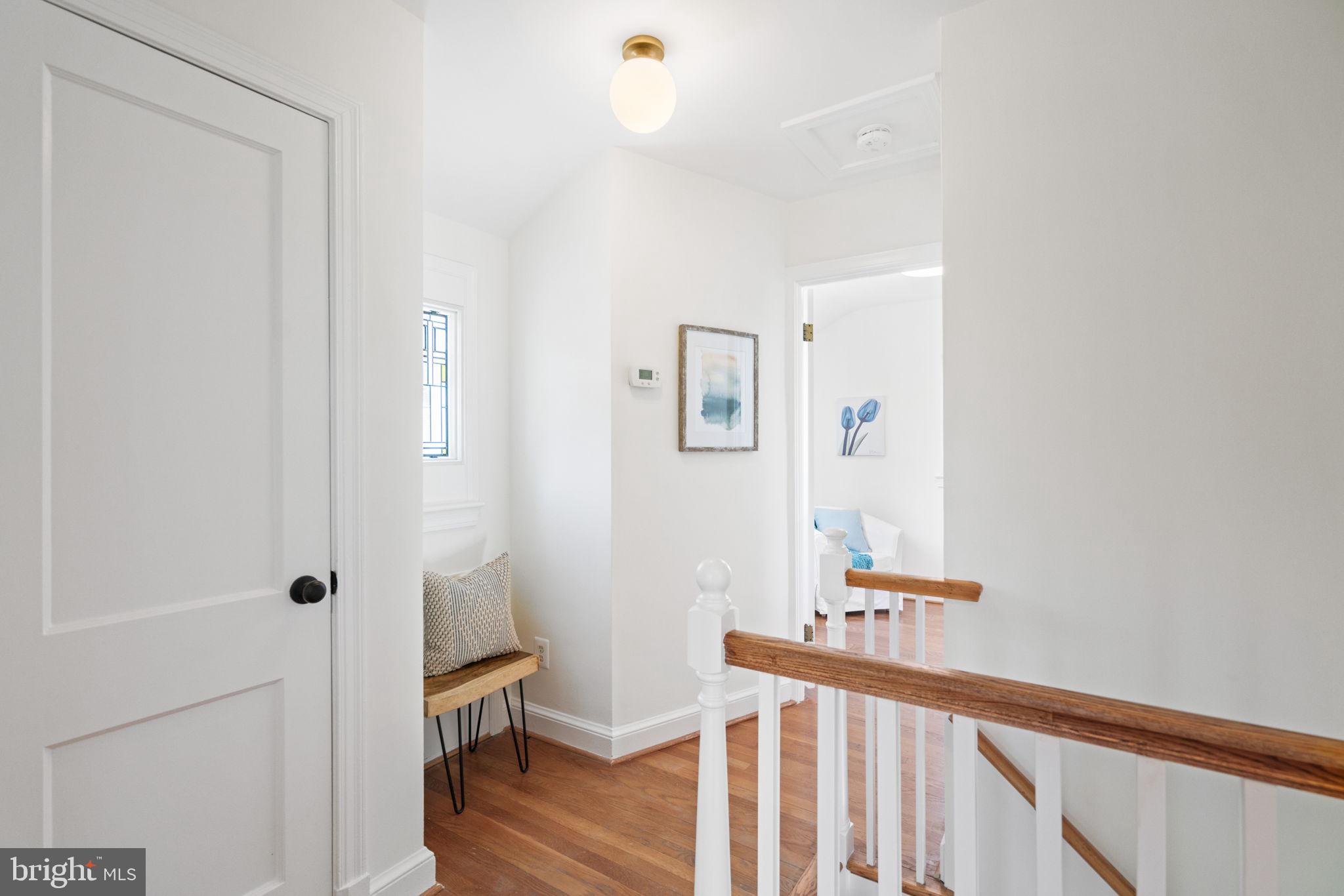 4900 Montgomery Avenue Bethesda, MD 20816 - Photo 24 of 57 a view of a hallway with wooden floor and a bathroom
