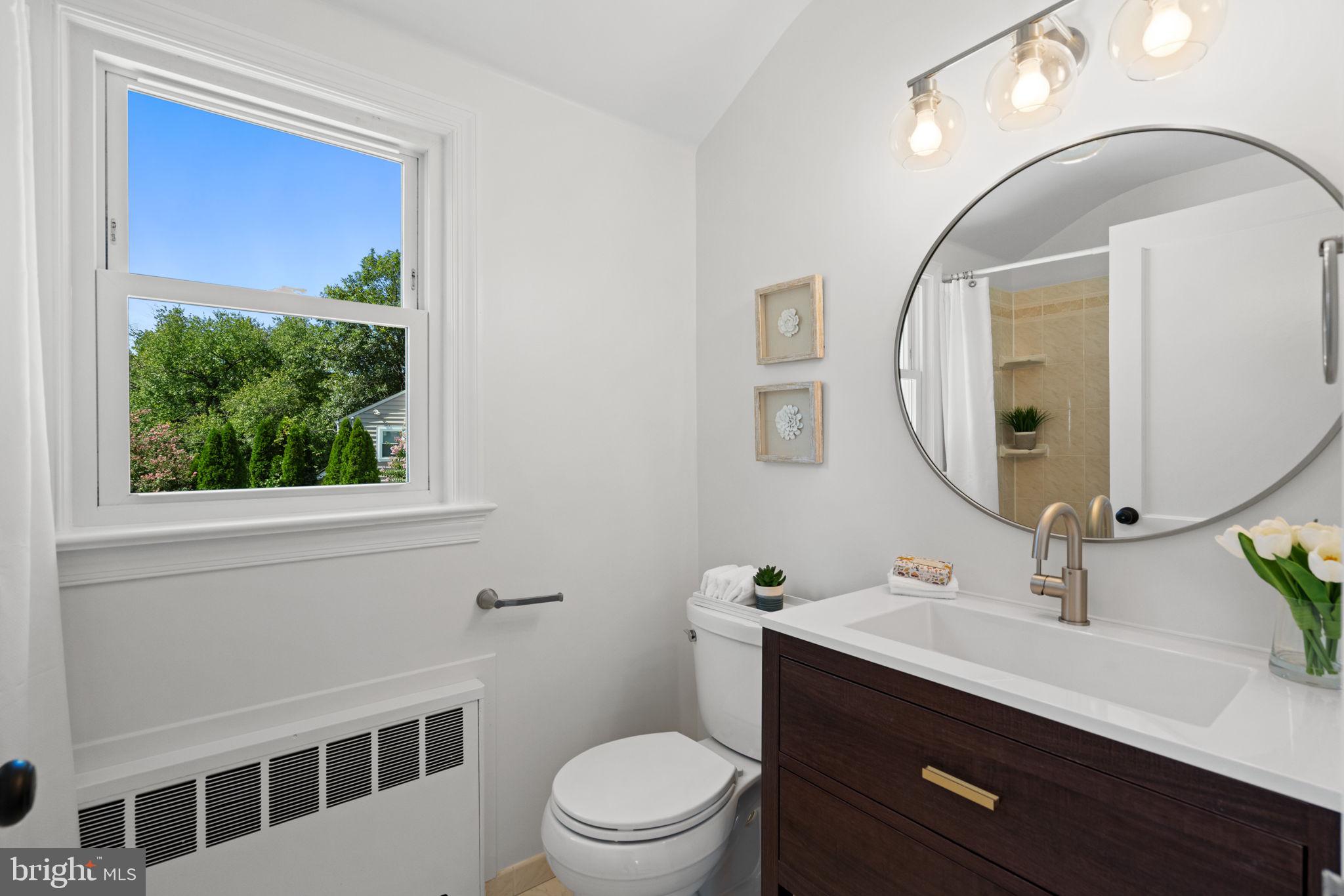 4900 Montgomery Avenue Bethesda, MD 20816 - Photo 28 of 57 a bathroom with a sink a toilet a mirror and shower