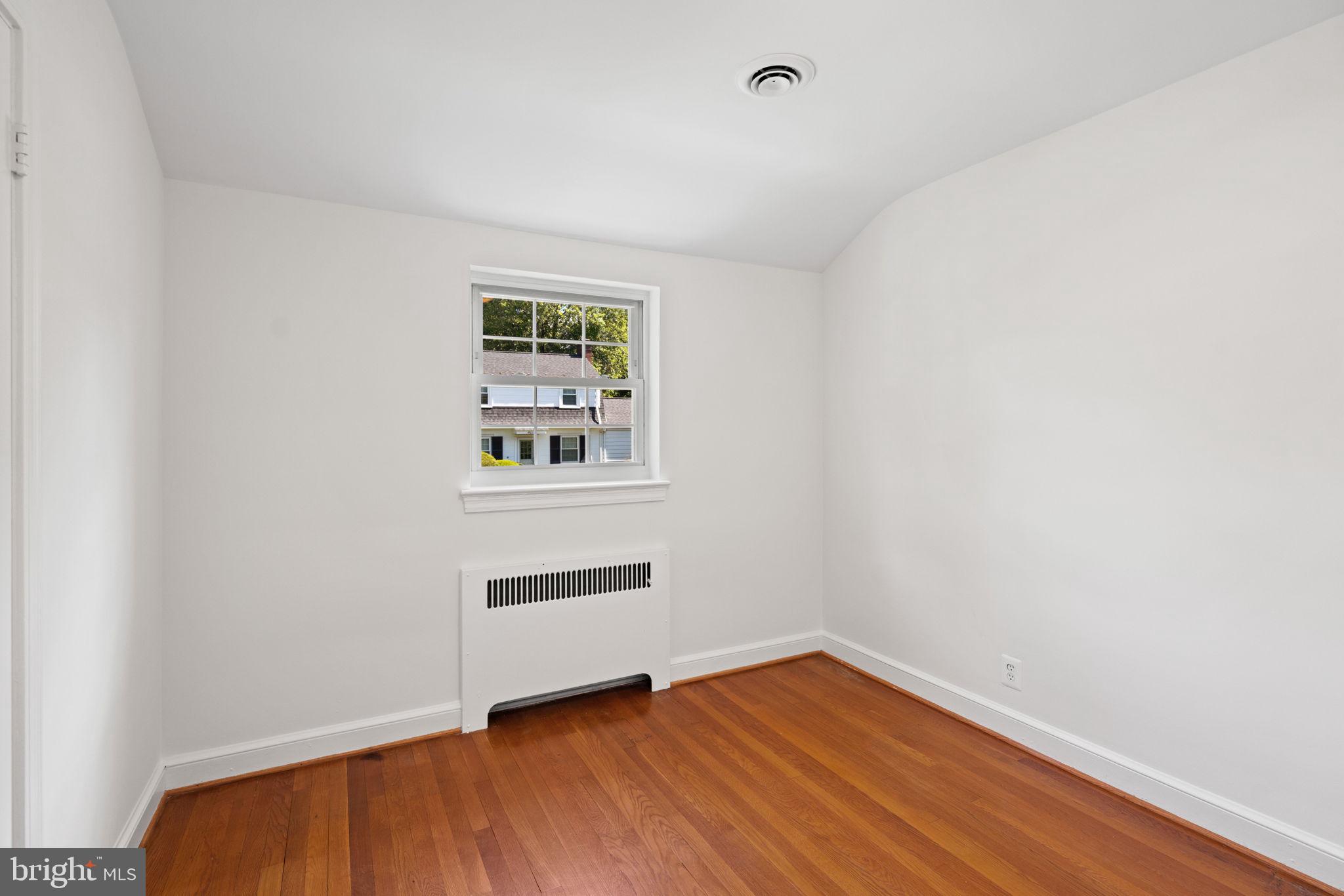 4900 Montgomery Avenue Bethesda, MD 20816 - Photo 30 of 57 a view of empty room with wooden floor and fan