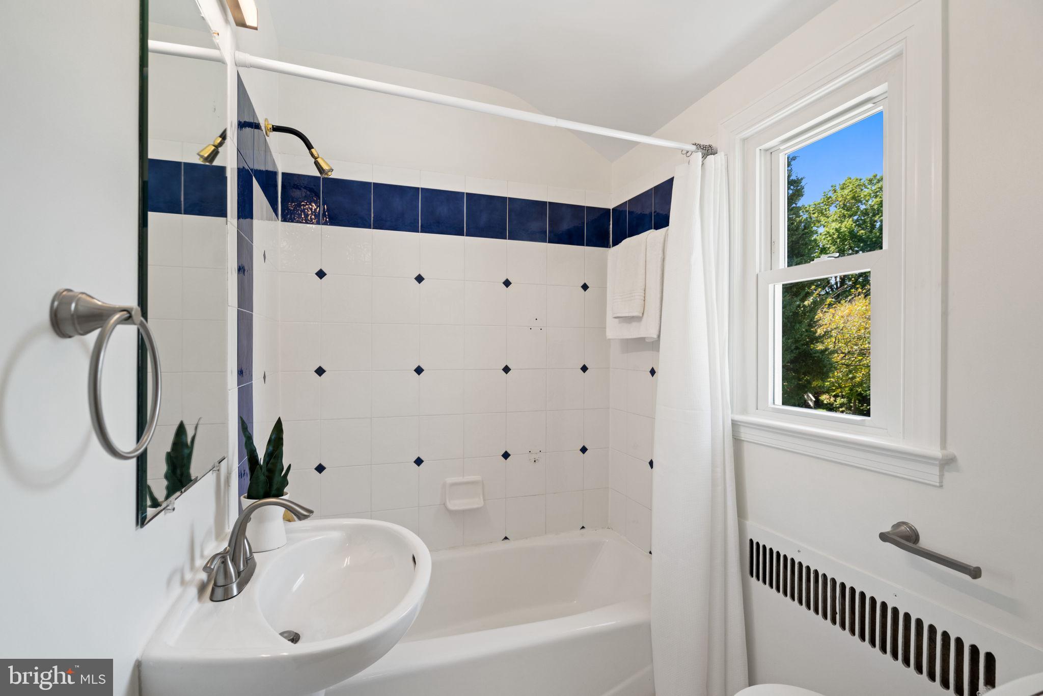 4900 Montgomery Avenue Bethesda, MD 20816 - Photo 34 of 57 a bathroom with a bathtub and a window