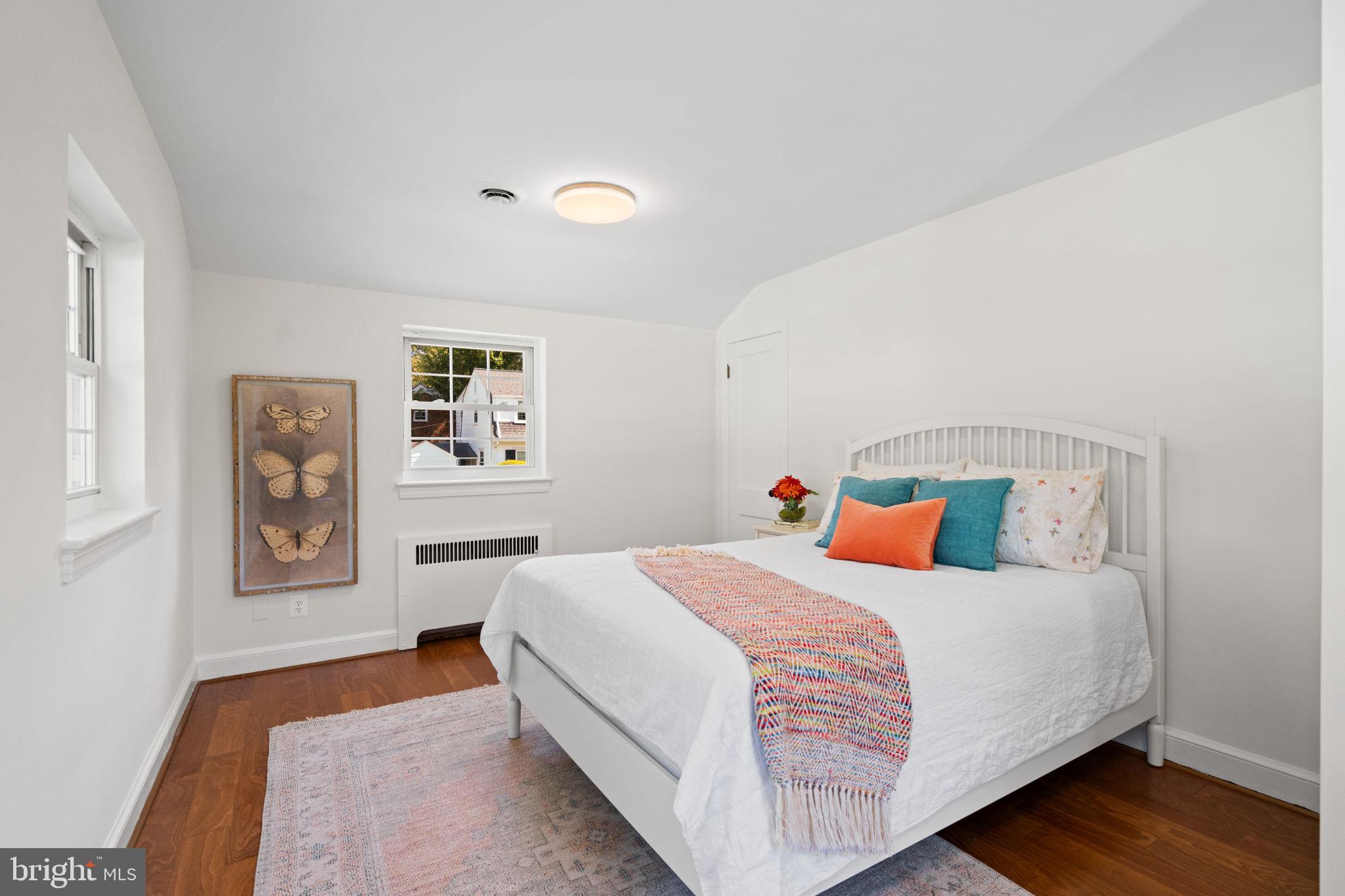 4900 Montgomery Avenue Bethesda, MD 20816 - Photo 35 of 57 a bedroom with a bed and painting on the wall