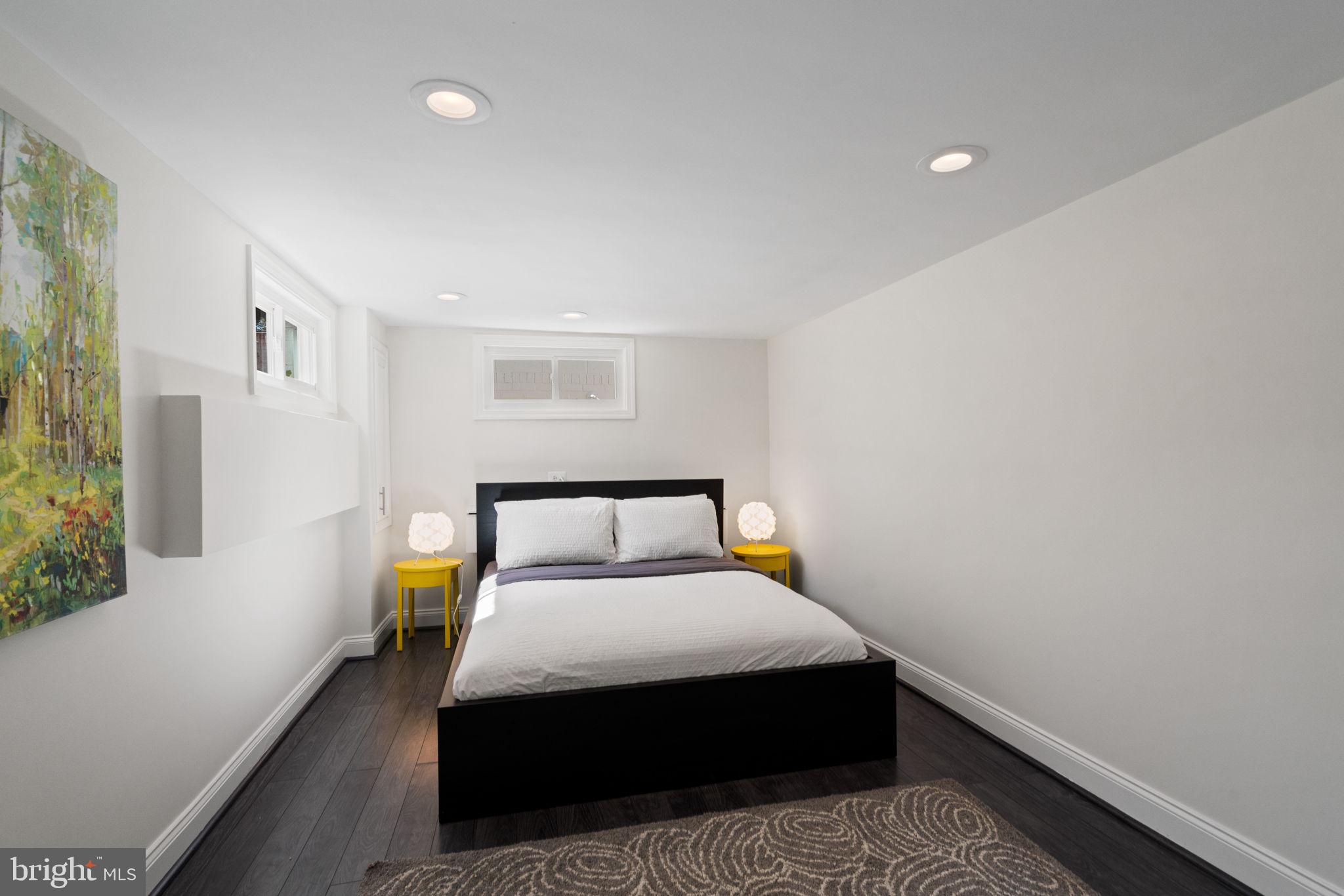 4900 Montgomery Avenue Bethesda, MD 20816 - Photo 37 of 57 a bedroom with a bed and wooden floor