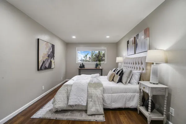 a bedroom with a bed and wooden floor