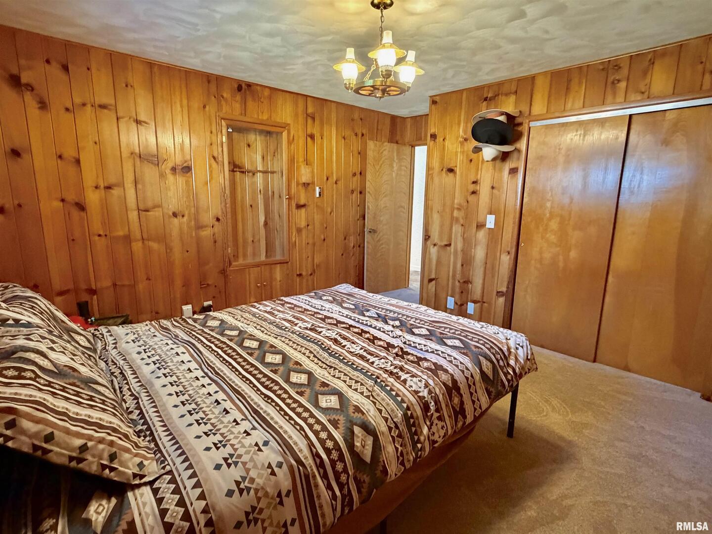 315 Hosselton Street Southwest Clay City, IL 62824 - Photo 24 of 70 a bedroom with a bed and a chandelier