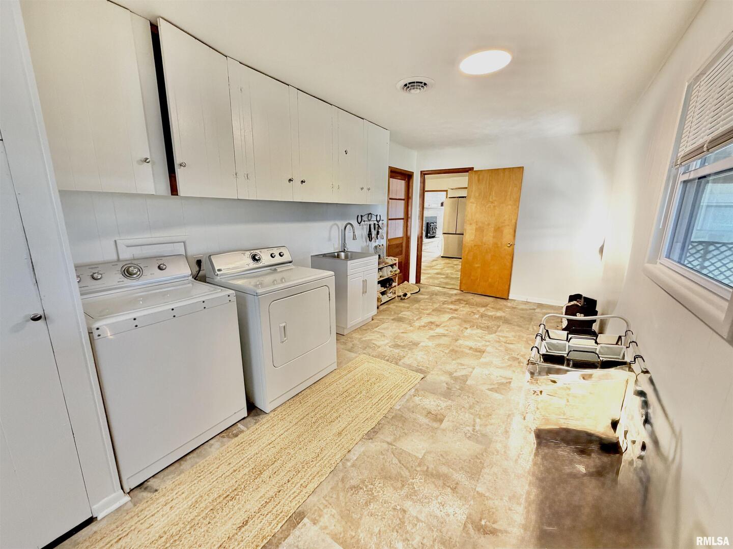 315 Hosselton Street Southwest Clay City, IL 62824 - Photo 46 of 70 a kitchen with a stove a sink and a refrigerator