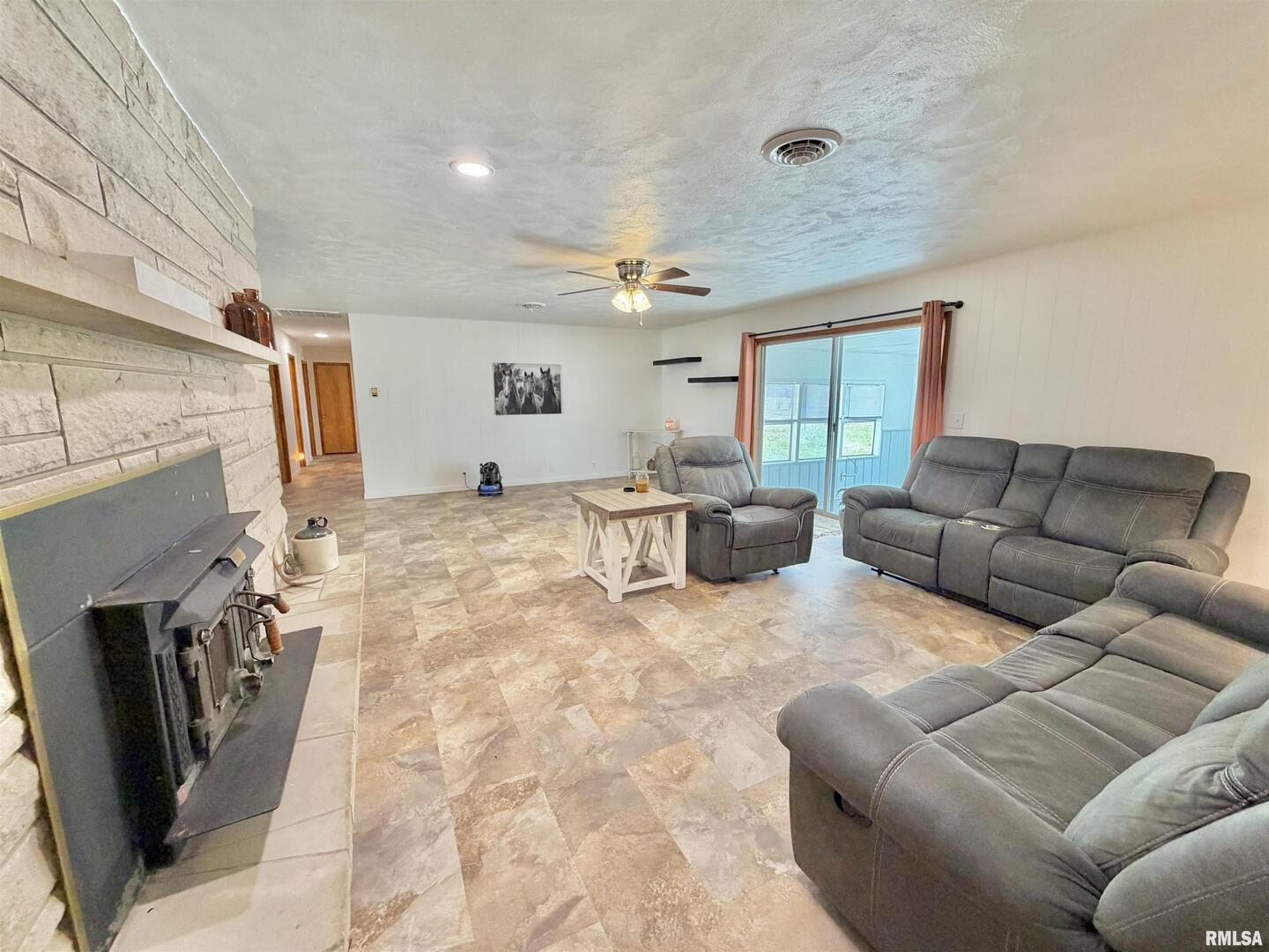 315 Hosselton Street Southwest Clay City, IL 62824 - Photo 49 of 70 a living room with furniture a large window and a fireplace