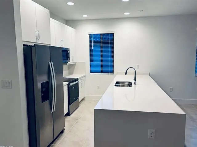 a kitchen with stainless steel appliances a refrigerator and a sink