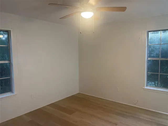 an empty room with windows and closet