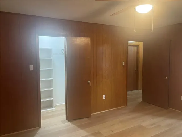 an empty room with closet area