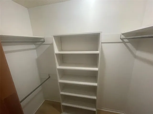 a white toilet sitting next to a shower