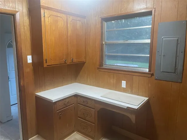 an aerial view of residential house with outdoor space and trees all around