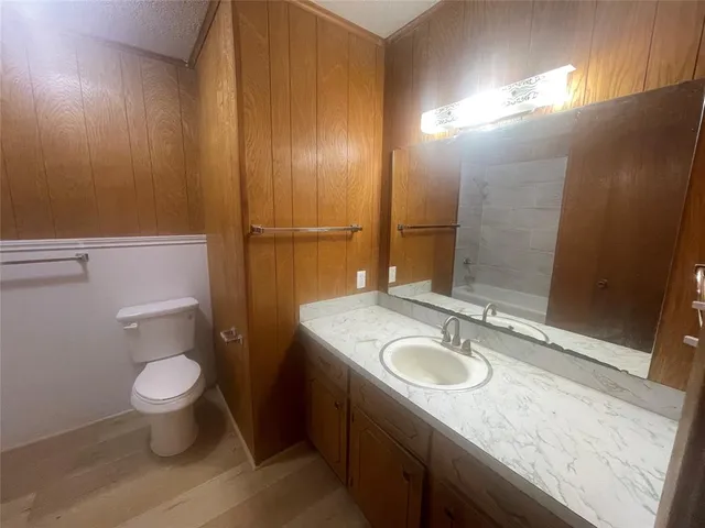 a white toilet sitting next to a bathtub