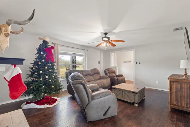 a living room with furniture and flowers