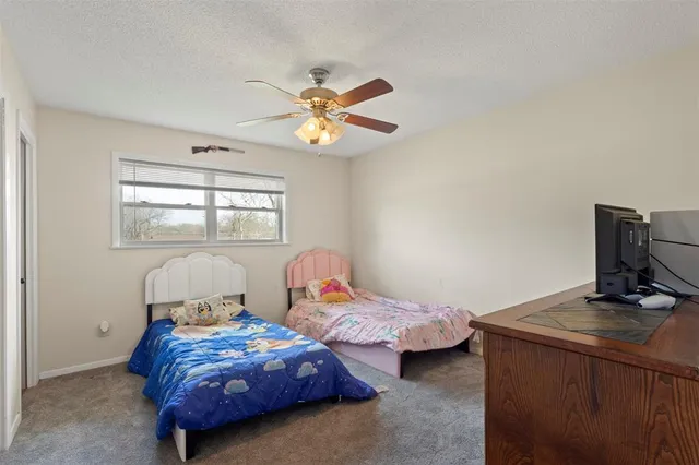a bedroom with two beds and a chandelier
