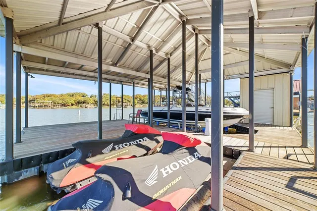 a kids room with large bed and a large window with outer view