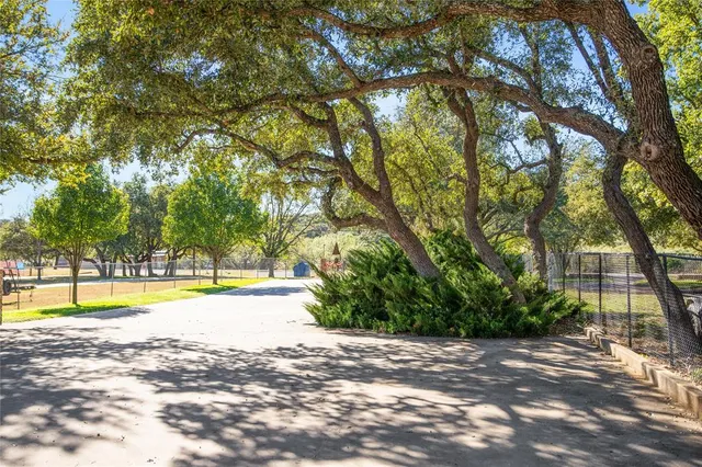 a view of swimming pool with trees in the background