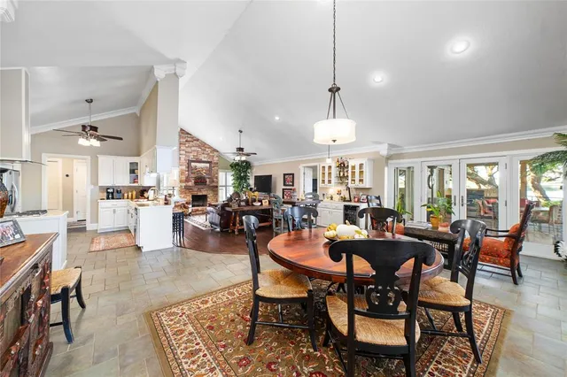 a dining room with furniture a rug and a chandelier