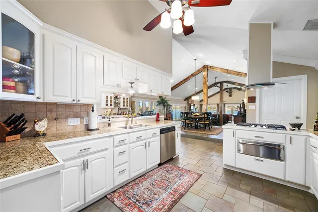 a kitchen with a stove cabinets and window