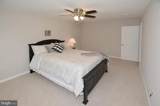 a bedroom with bed and a chandelier