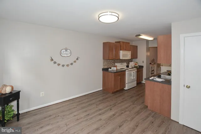 a kitchen with wooden floors and a fireplace
