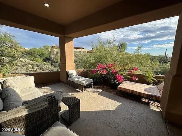 a living room with furniture and a floor to ceiling window