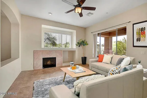 a living room with furniture and a fireplace